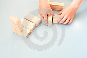 Child play with wood blocks on blue backgrounds