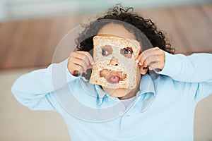 Child, playful or face food mask or bread funny, nutrition hungry or eating health value. Boy, tongue or brown diet