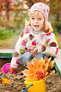 Child on playground in autumn