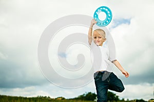 Child in playground kid in action boy playing with frisbee