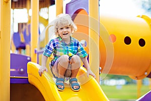 Child on playground. Kids play outdoor