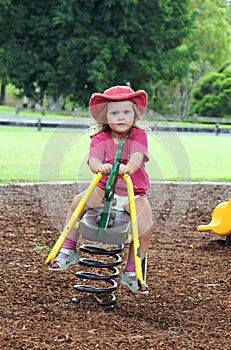 Child on playground seesaw photo