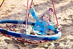 Child on playground swing