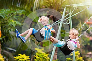 Child on playground. swing Kids play outdoor photo