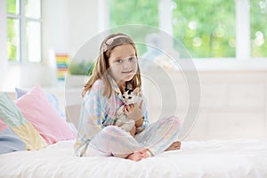 Child playing with baby cat. Kid and kitten