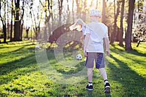 Child playing ball with mother in park.