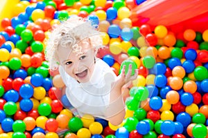 Child playing in ball pit on indoor playground