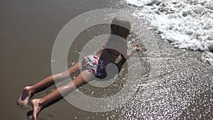 Child Playing on Beach, Kid on Seashore, Blonde Kid Plays in Sand by Sea Waves, Children in Summer Vacation