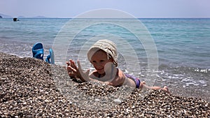 Child Playing on Beach, Kid Throwing Pebbles in Sea Waves on Seashore, Little Girl Plays on Coastline Shore in Summer Vacation