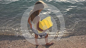 Child Playing on Beach in Sunset, Kid Watching Sea Waves, Girl View at Sundown