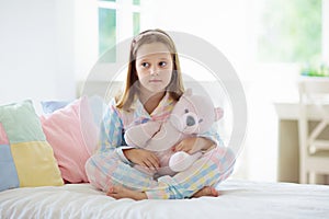 Child playing in bed. Kids room. Girl at home