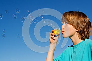 Child playing blowing bubbles