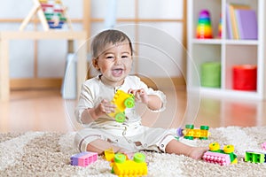 Child playing with building blocks at home