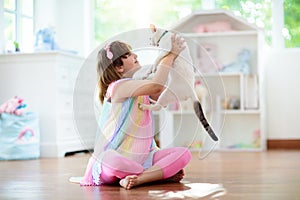 Child playing with cat at home. Kids and pets