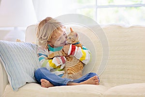 Child playing with cat. Kid and kitten