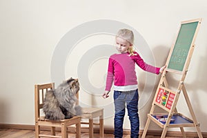 Child playing with cat school.