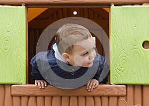 Child playing in a children playhouse.