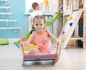 Child is playing in the children`s room. Children in the entertainment center. Fun in the children`s playroom