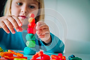 Child playing with clay molding shapes, kids crafts