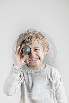 Child playing with coffee capsules