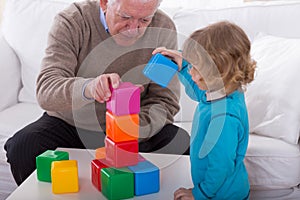 Child playing with color cubes