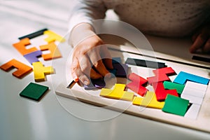 A child playing a colored puzzle on the table