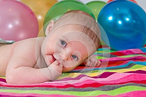 Child playing with colorful balloons