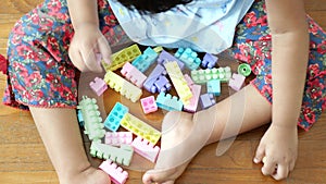 child playing with colorful building blocks top view