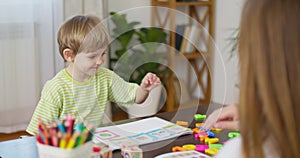 Child Playing with Colorful Learning Blocks