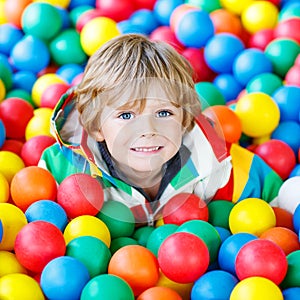 Child playing at colorful plastic balls playground