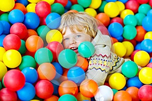 Child playing at colorful plastic balls playground