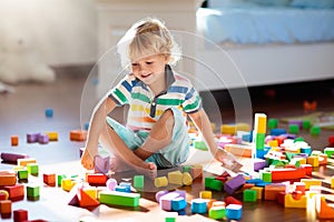 Child playing with colorful toy blocks. Kids play