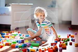 Child playing with colorful toy blocks. Kids play