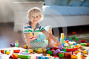 Child playing with colorful toy blocks. Kids play