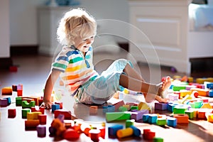 Child playing with colorful toy blocks. Kids play