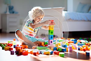 Child playing with colorful toy blocks. Kids play