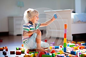 Child playing with colorful toy blocks. Kids play