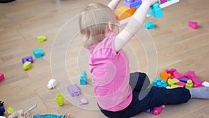 Child playing with colorful toy blocks. Kids play. Educational game for baby and toddler