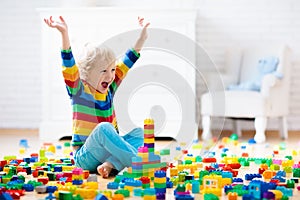 Child playing with toy blocks. Toys for kids.