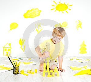 Child playing with construction blocks. Creativity