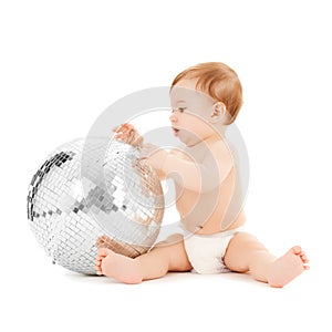 Child playing with disco ball