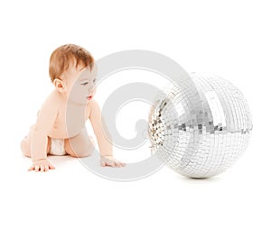 Child playing with disco ball