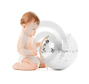 Child playing with disco ball