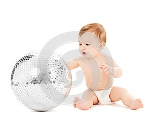 Child playing with disco ball