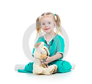 Child playing doctor and examining toy