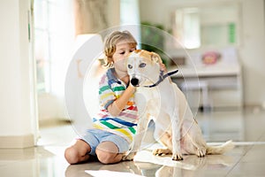 Child playing with dog. Kids play with puppy