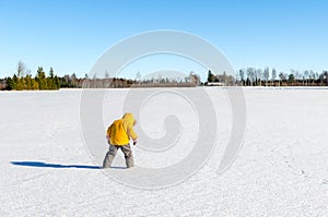 A child playing in a field of snow