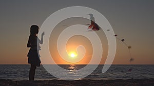 Child Playing Flying Kite on Beach at Sunset, Happy Little Girl on Coastline