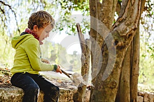 Child playing freely in nature learning in a forest school, new alternative education