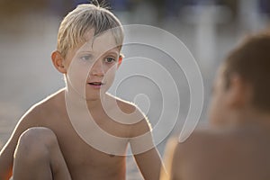 child playing with friend on the beach summertime